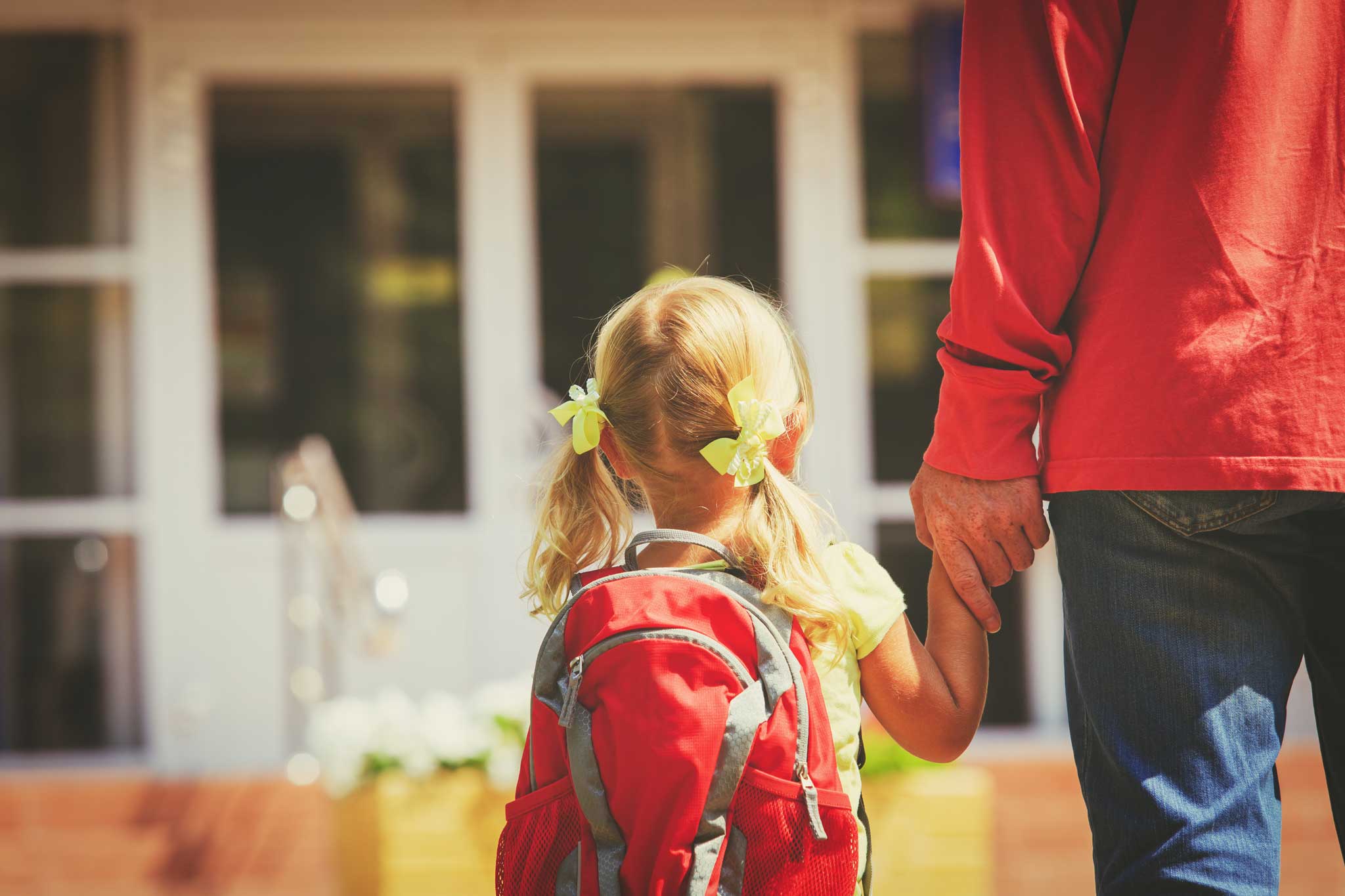 parent walking young child into school