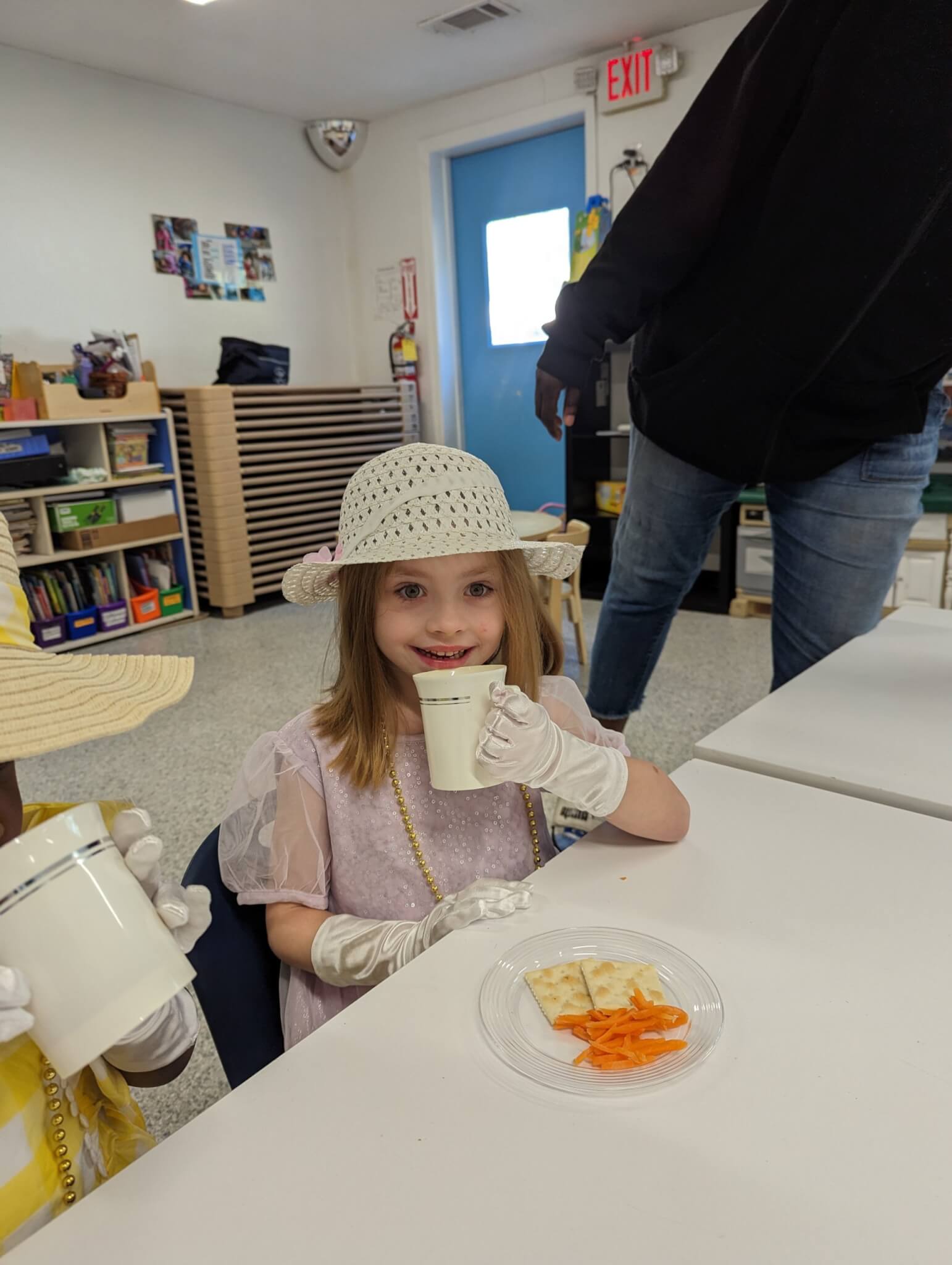 Young girl taking sip of a drink